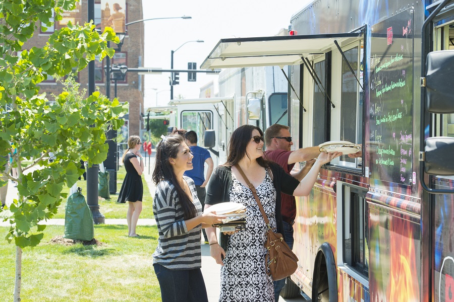 Customers waiting in line in front of a foodtruck